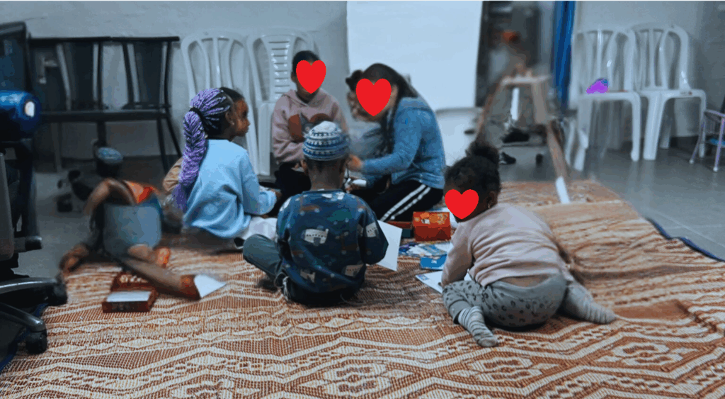 Children doing activities in a bomb shelter (Kiryat Menachem)